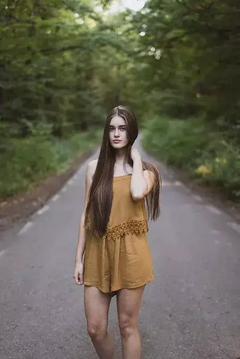 girl holding hand behind neck