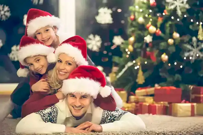 family pile with Santa hats