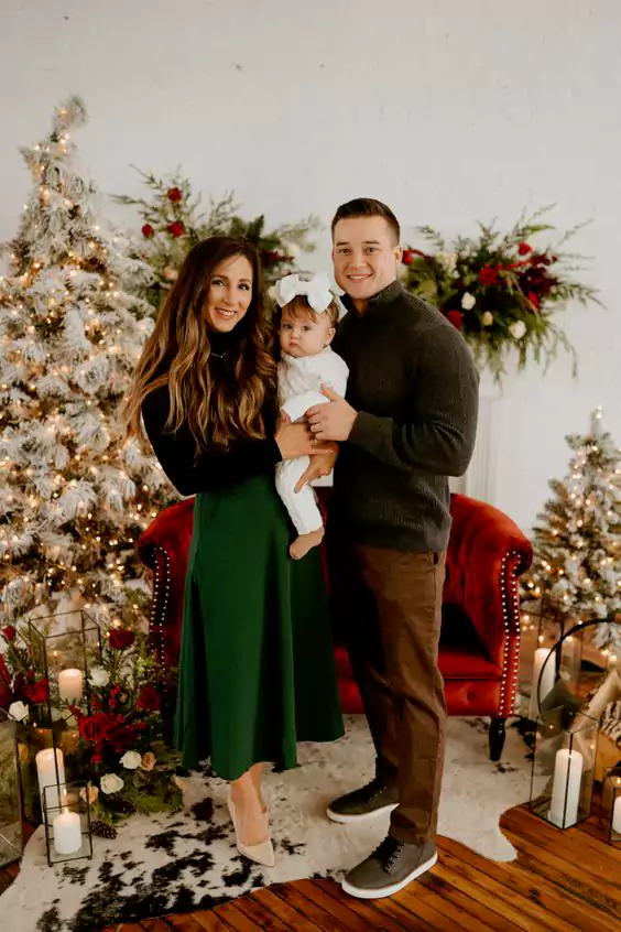 wearing casual dress and pose in front of a Christmas tree