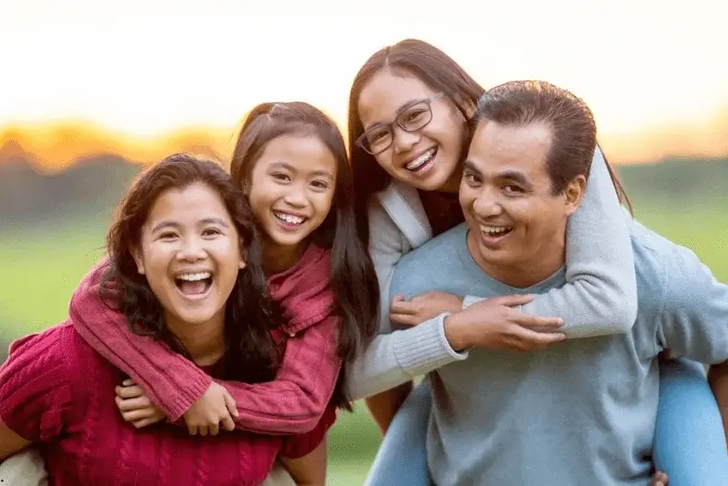 A family is smiling for the camera