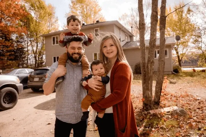 A group standing in front of a house